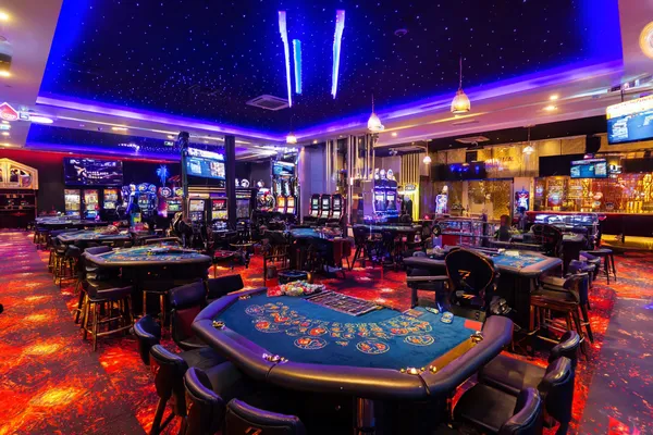 A glamorous woman holding casino chips in a neon-lit environment, representing the premium online casino atmosphere of 5666BET.